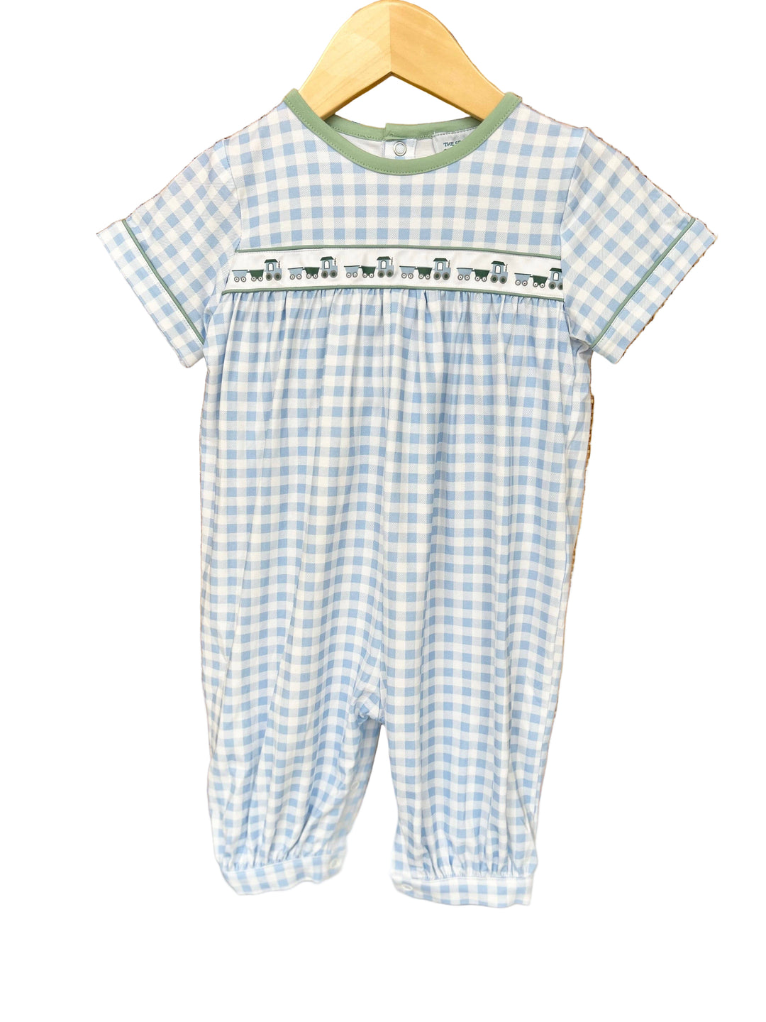 Blue and white checkered baby romper with a train ribbon across the bodice.